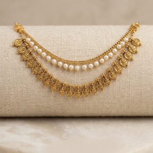A two-layered drape design connected by structured gold-toned end-links