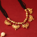 Traditional Indian Mangalsutra Featuring  Black Beaded Necklace And  Gold-Toned, Red-Stoned Pendant