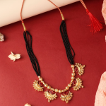 Traditional Indian Mangalsutra Featuring  Black Beaded Necklace And  Gold-Toned, Red-Stoned Pendant